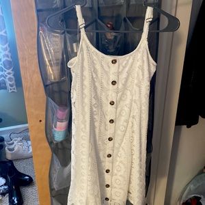 White lace dress with brown buttons.